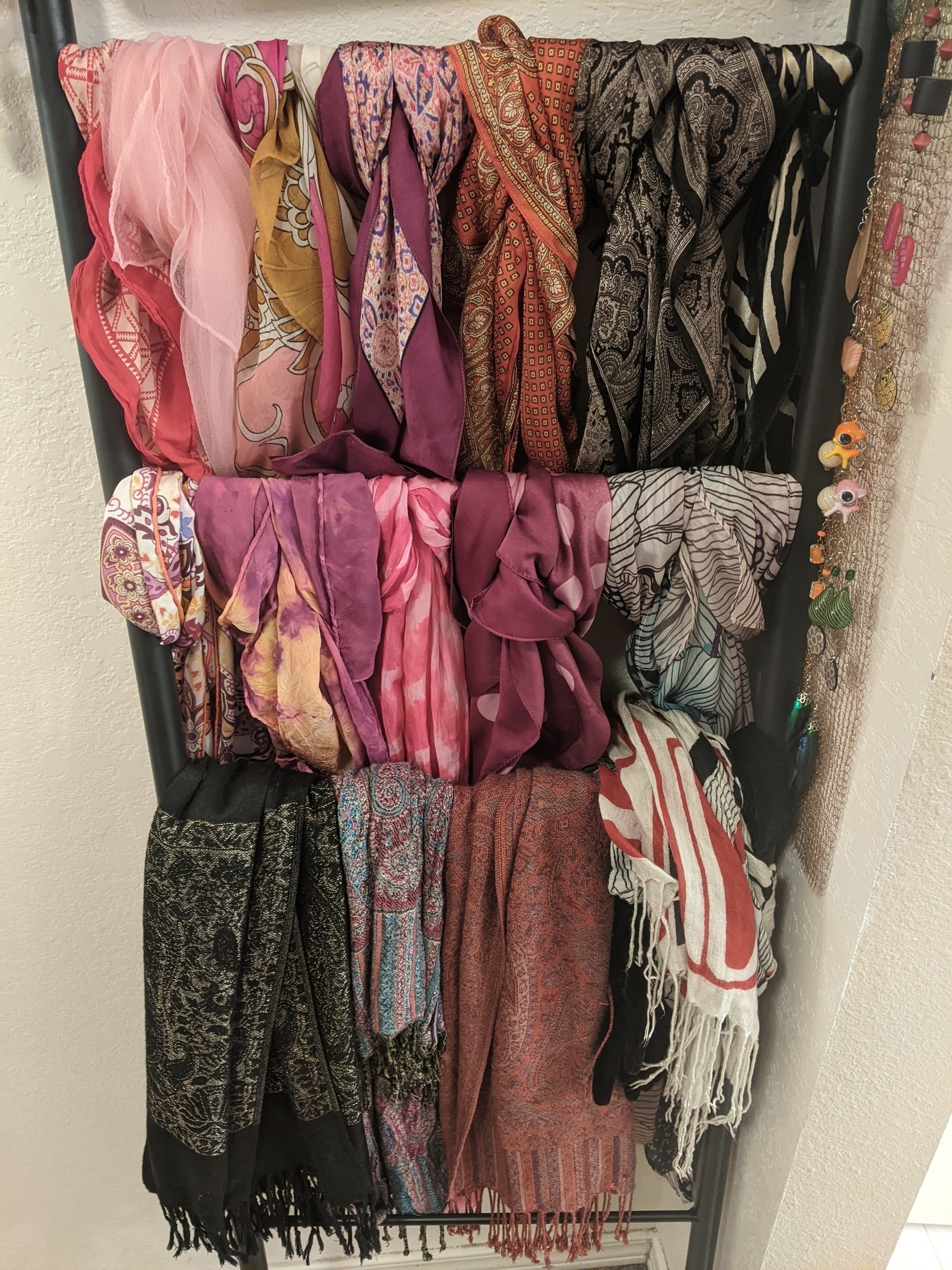 colorful scarves hung on a decorative ladder
